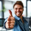 person smiling in the office and doing a thumb up